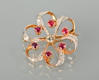 Lot 1347 - RUBY AND DIAMOND FLOWER BROOCH of scrolling...