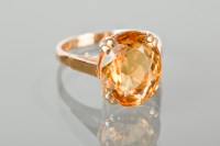 Lot 1364 - CITRINE DRESS RING set with an oval citrine...
