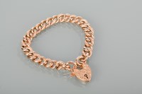 Lot 1407 - NINE CARAT GOLD CURB LINK BRACELET with a...