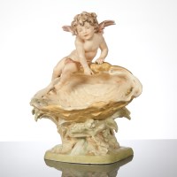 Lot 151 - ROYAL DUX COMPORT with cherub atop a shell, on...