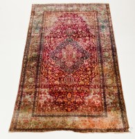 Lot 421 - KASHAN SILK RUG with floral aubergine field...