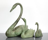 Lot 435 - SET OF THREE GREEN PATINATED BRONZE SWANS of a...