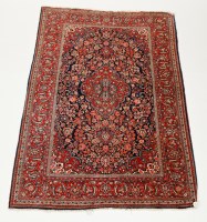Lot 514 - ANTIQUE PERSIAN RUG in red and blue floral...