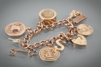 Lot 1128 - NINE CARAT GOLD CHARM BRACELET with charms...