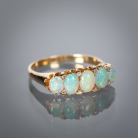 Lot 1131 - OPAL AND DIAMOND DRESS RING the five graduated...