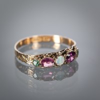 Lot 1132 - VICTORIAN MULTI GEM SET RING the central round...