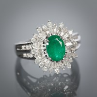 Lot 1147 - EMERALD AND DIAMOND CLUSTER RING the central...