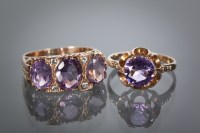 Lot 1150 - TWO AMETHYST DRESS RINGS one set with a single...