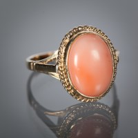 Lot 1152 - CORAL DRESS RING set with a single large oval...