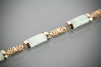 Lot 1153 - NINE CARAT GOLD JADE SET BRACELET with curved...