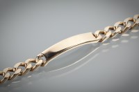 Lot 1160 - NINE CARAT GOLD BRACELET with a blank curved...