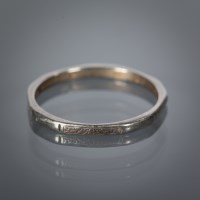 Lot 1172 - PLATINUM WEDDING BAND with engraved sections,...