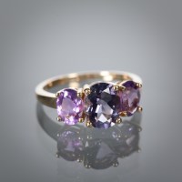 Lot 1175 - AMETHYST DRESS RING with three oval cut...