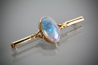 Lot 1182 - OPAL BAR BROOCH set with a large oval blue...