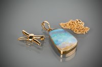 Lot 1183 - OPAL PENDANT the opal 27x19mm in fifteen carat...