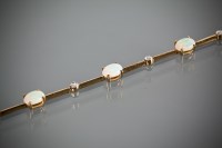 Lot 1188 - OPAL AND DIAMOND BRACELET with oval opals...