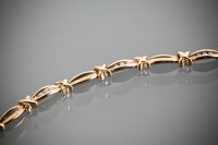 Lot 1189 - NINE CARAT GOLD DIAMOND SET BRACELET with...