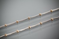 Lot 1190 - NINE CARAT GOLD BI-COLOUR NECKLACE AND...