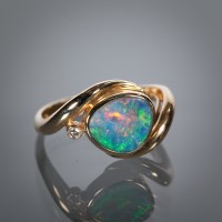 Lot 1192 - OPAL AND DIAMOND SET DRESS RING the central...