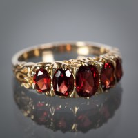 Lot 1195 - GARNET FIVE STONE RING the Victorian style...