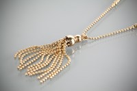 Lot 1200 - GOLD TASSEL PENDANT ON CHAIN the pendant...