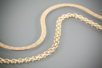 Lot 1201 - TWO NINE CARAT GOLD NECKLACES c.1970s, one...