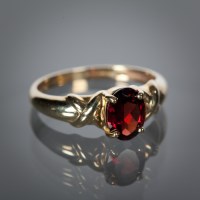 Lot 1210 - GARNET DRESS RING set with an oval garnet, size N