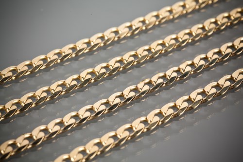 Lot 1212 - THREE NINE CARAT GOLD NECKLACES AND A NINE...