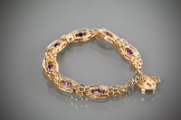 Lot 1221 - NINE CARAT GOLD AMETHYST SET BRACELET set with...