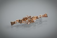 Lot 1227 - NINE CARAT GOLD DIAMOND SET BROOCH the satin...