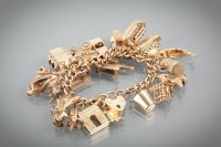 Lot 1281 - NINE CARAT GOLD CHARM BRACELET with numerous...