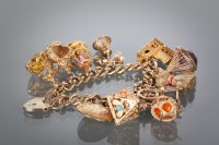 Lot 1329 - NINE CARAT GOLD CHARM BRACELET c.1960s, the...