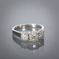 Lot 1334 - DIAMOND CLUSTER RING set with three graduated...