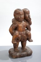 Lot 63 - AFRICAN WOOD CARVING of two boys, one carrying...