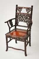 Lot 208 - CHINESE HARDWOOD ARMCHAIR richly carved with...