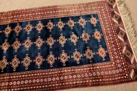 Lot 379 - MODERN BOKHARA RUG the indigo field with three...
