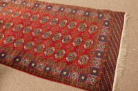 Lot 380 - BOKHARA RUG with three rows of guls, within a...