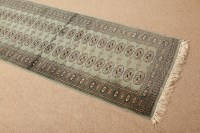 Lot 389 - BOKHARA RUNNER with green field of rows of...