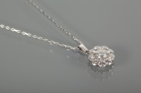 Lot 1102 - FINE DIAMOND CLUSTER PENDANT the central...