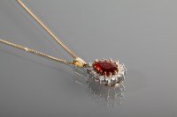 Lot 1158 - RED GEM AND DIAMOND SET CLUSTER PENDANT with a...