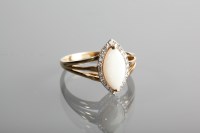 Lot 1180 - OPAL AND DIAMOND CLUSTER RING with a central...