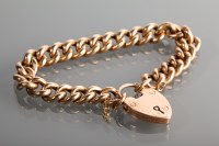 Lot 1185 - NINE CARAT GOLD CURB LINK BRACELET with heart...