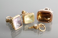 Lot 1186 - THREE GEM SET FOBS AND A WATCH KEY all...