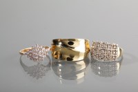 Lot 1193 - THREE NINE CARAT GOLD RINGS one with a gem set...