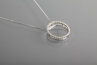 Lot 1199 - WHITE GOLD DIAMOND SET PENDANT of circular...