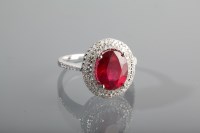 Lot 1259 - RUBY AND DIAMOND DRESS RING the central oval...