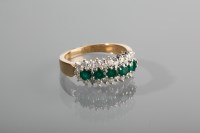 Lot 1277 - EMERALD AND DIAMOND RING the central row of...