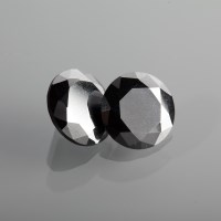 Lot 1343 - TWO UNMOUNTED BLACK DIAMONDS the round stones...