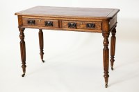 Lot 223 - LATE VICTORIAN OAK WRITING TABLE with red...