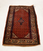 Lot 419 - PERSIAN MAT with boteh on a red ground, 130cm...